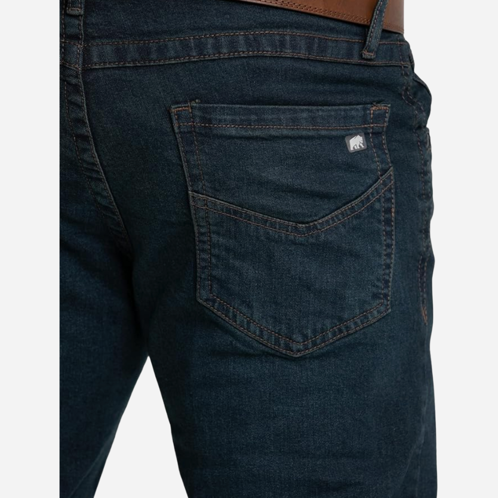 Dark blue jeans with a brand logo on the pocket against a white background