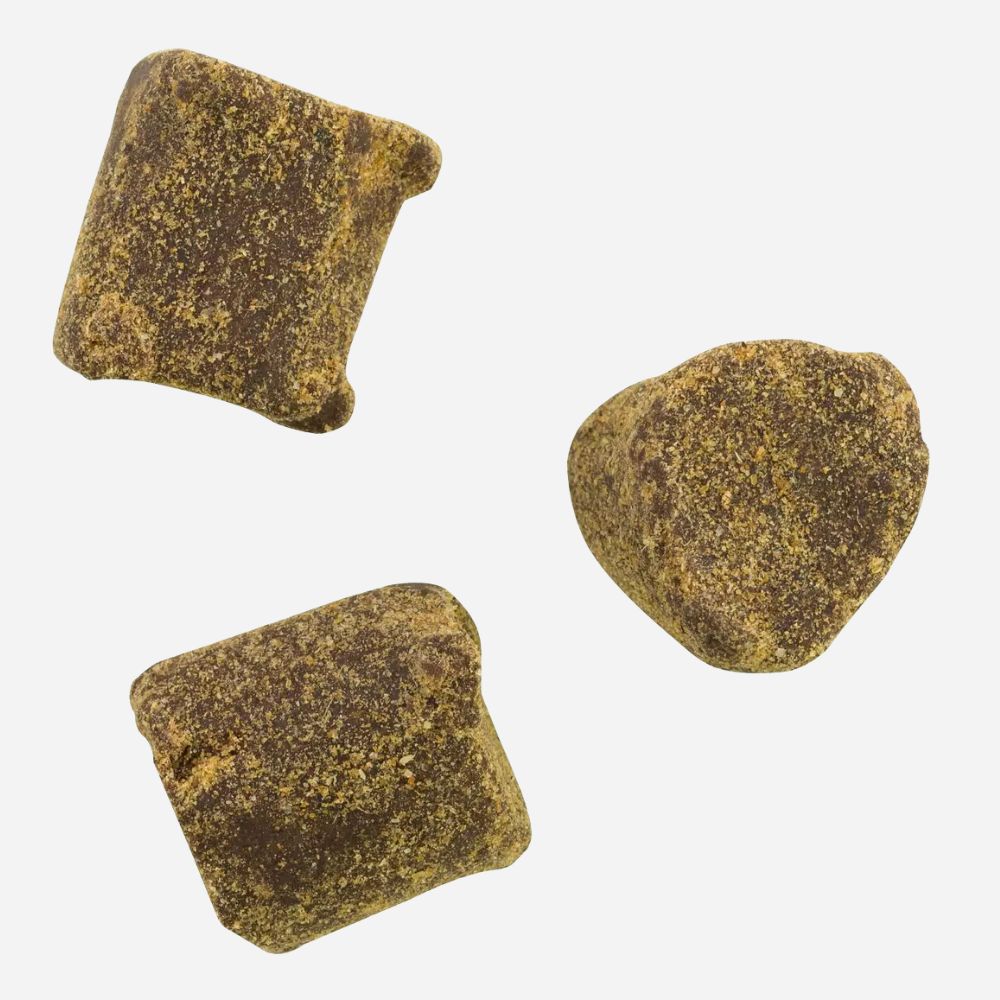 Three brownish pet treats on a white background