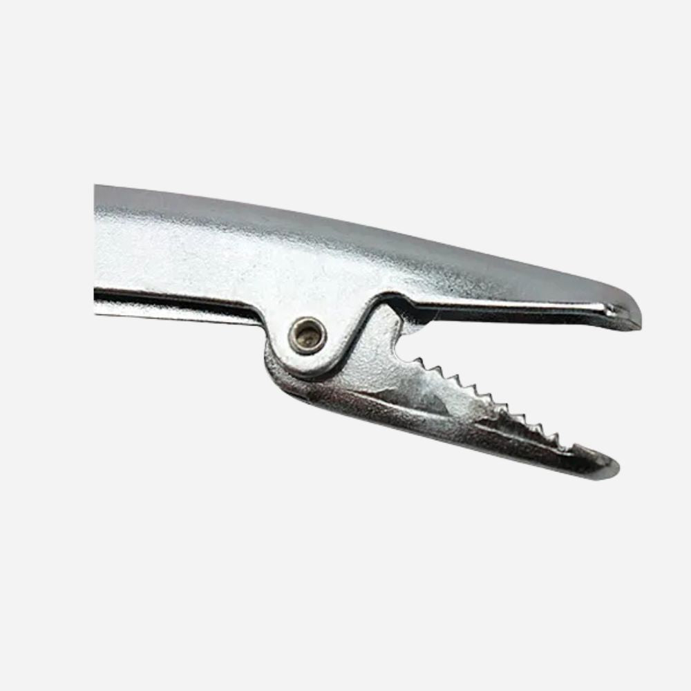 A close-up of a metallic silver spring clamp or anvil tool against a plain light gray background.