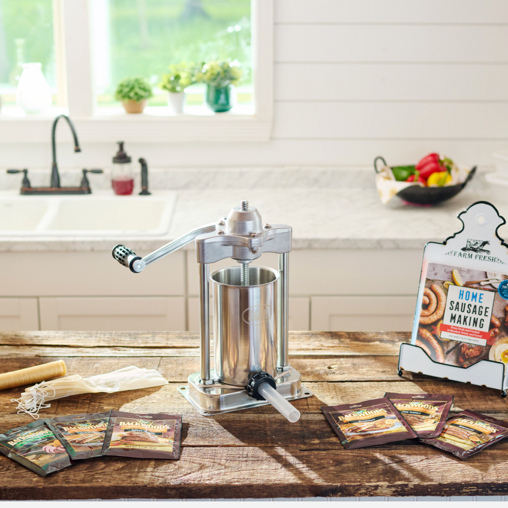 Sausage stuffer on a kitchen counter with packaging in the background
