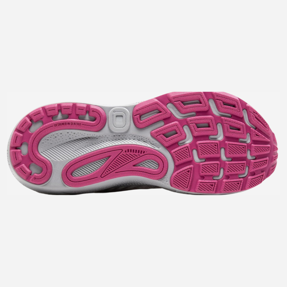 Close-up of a running shoe with pink and gray sole on a white background