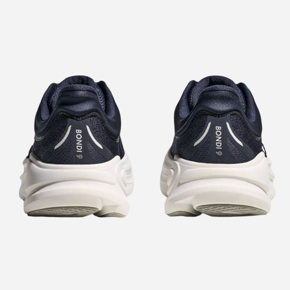 Navy running shoes with white soles on a light gray background