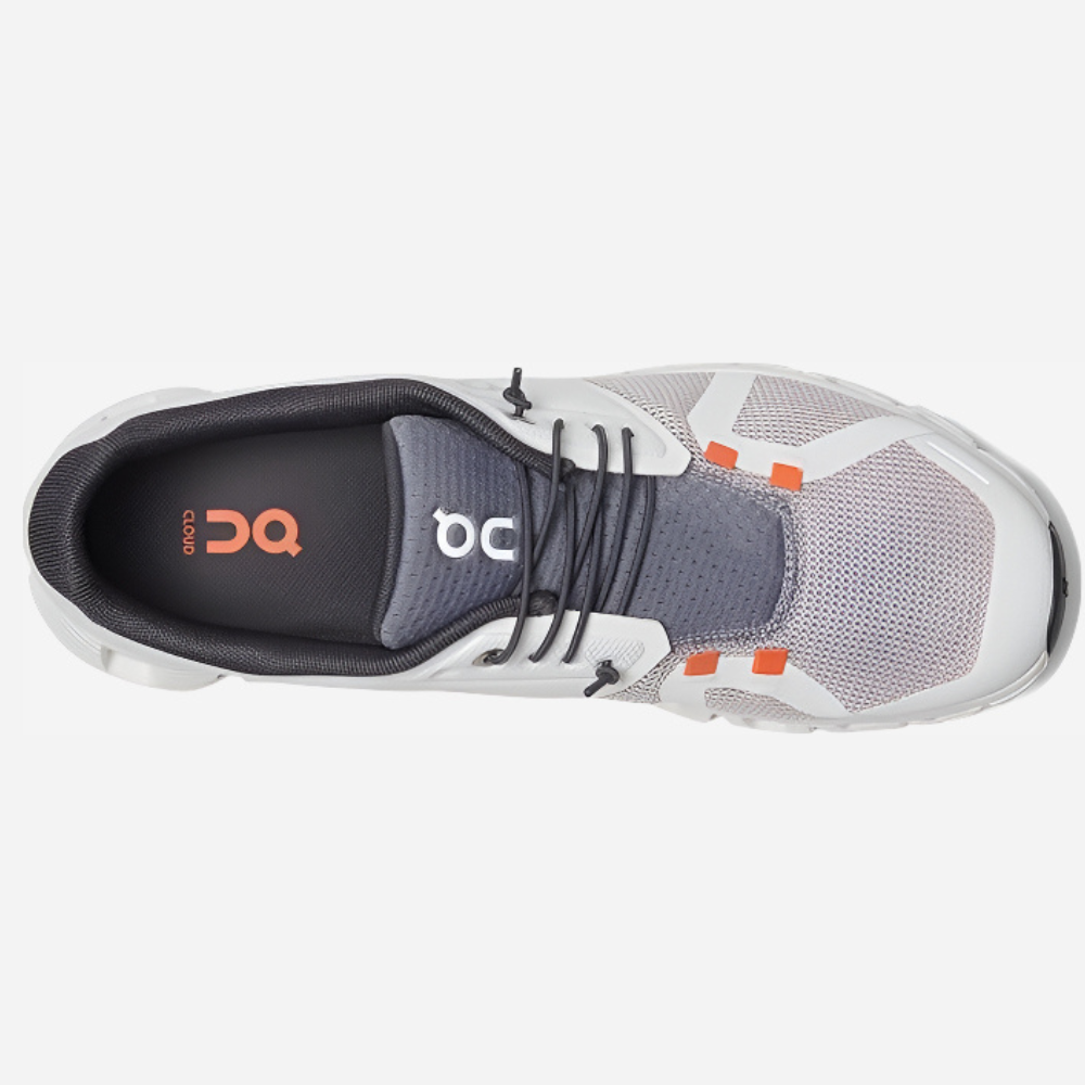 Gray and white athletic shoe with orange accents on a white background