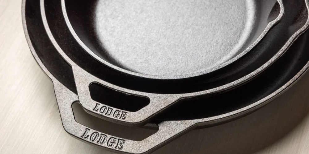 A stack of 3 different sizes of Lodge Cast Iron skillet 