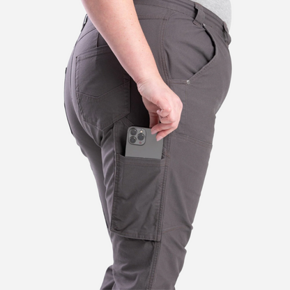 Person wearing gray cargo pants with a phone in one of the pockets on a white background