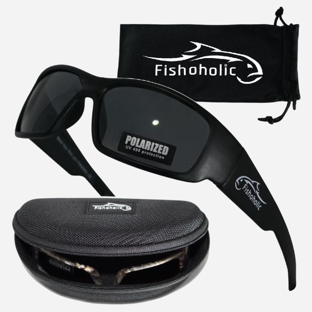 Black polarized sunglasses with a matching black drawstring pouch and hard case, both branded Fishoholic, shown on a light gray background.