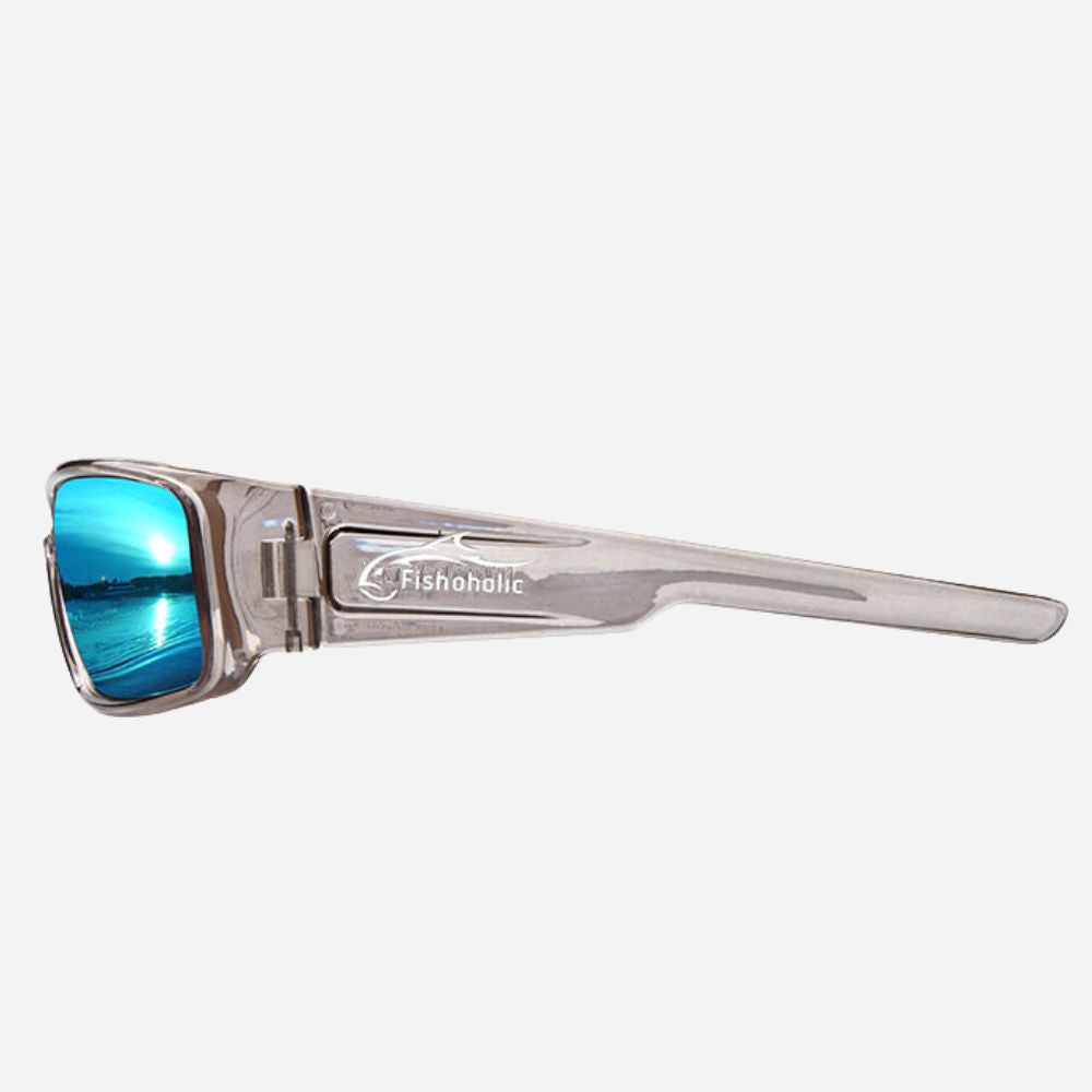 A pair of silver-framed sunglasses with blue mirrored lenses, featuring the Fishoholic logo on the temple, set against a light gray background.