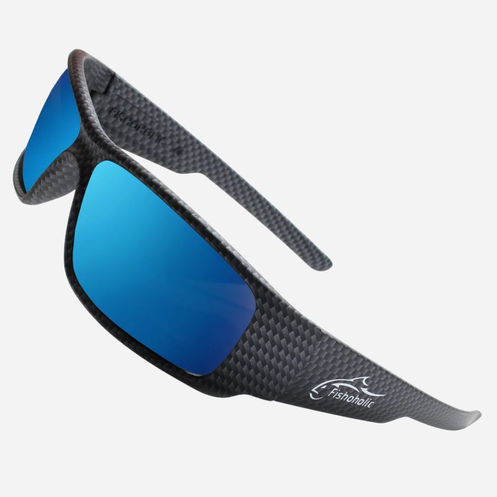 Fishabite wrap-around sunglasses with a black carbon fiber textured frame and vibrant blue mirrored lenses, shown on a light gray background.