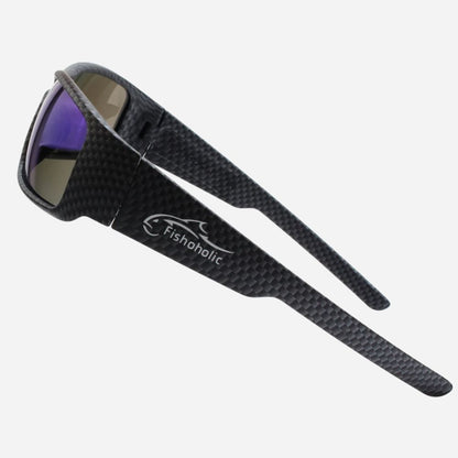 Black carbon-fiber-textured sunglasses with purple mirrored lenses and a white Fishoholic logo on the temple, shown on a light gray background.