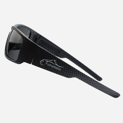 Black carbon-fiber-textured sunglasses with dark lenses and a visible Fishonolic logo on the temple, shown on a light gray background.