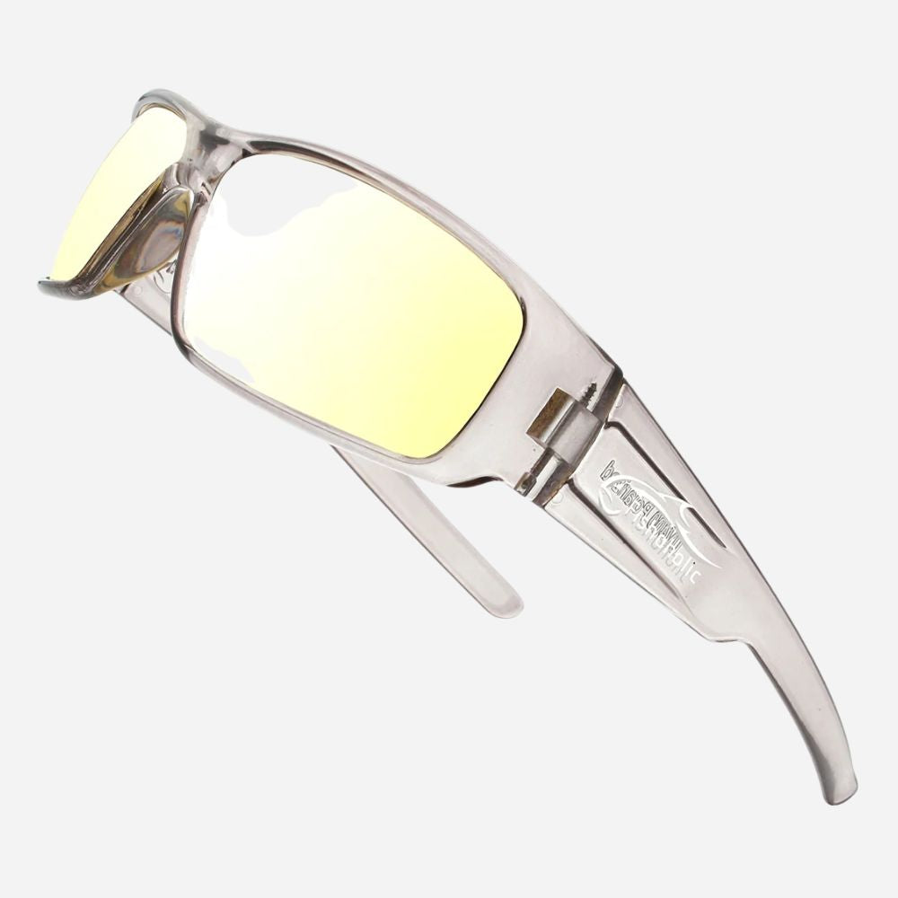 A pair of sport sunglasses with a clear, semi-transparent frame and yellow tinted lenses, shown against a light gray background.