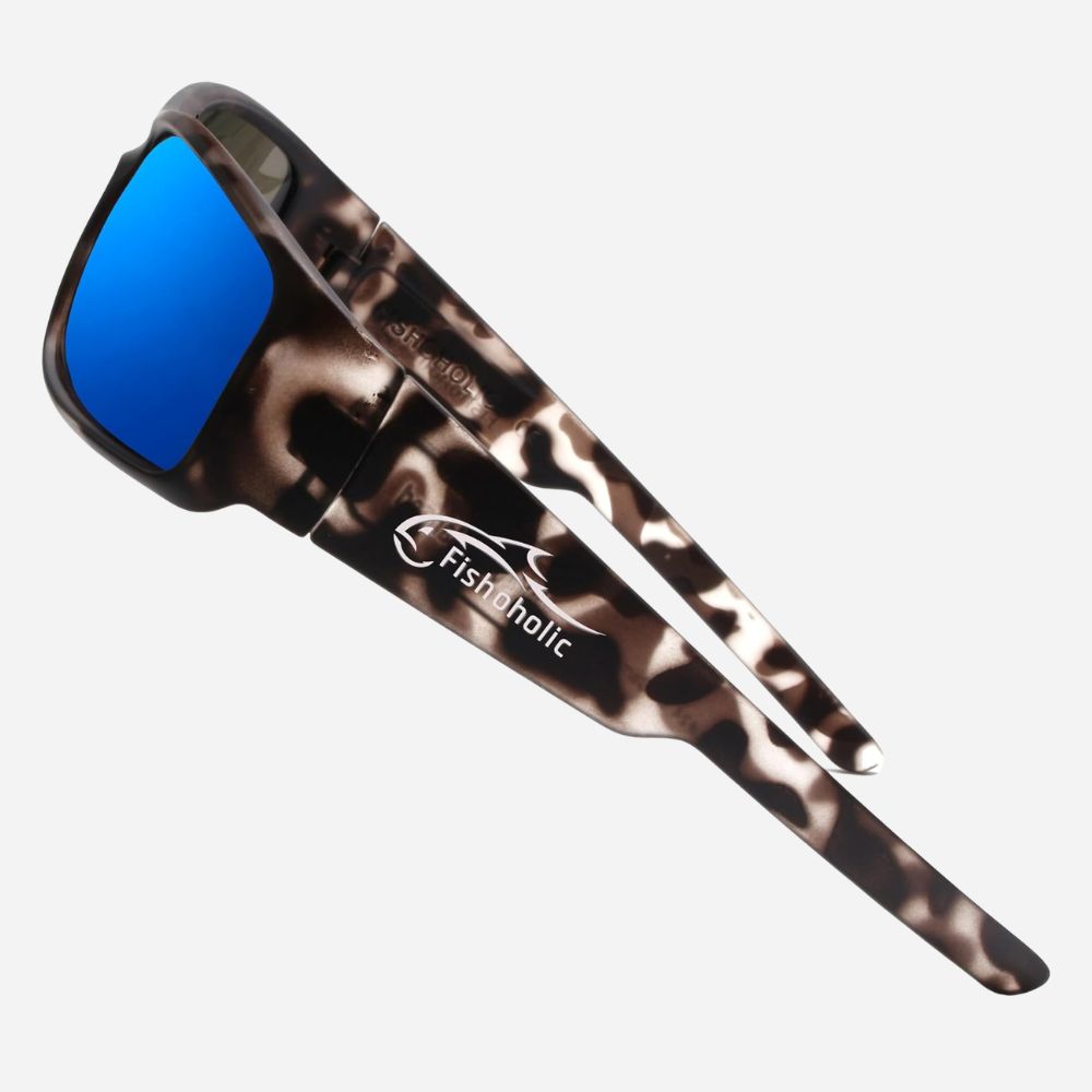 Fishing sunglasses with a brown and black tortoiseshell patterned frame and bright blue mirrored lenses, featuring the Fishholic logo on the temple arm.