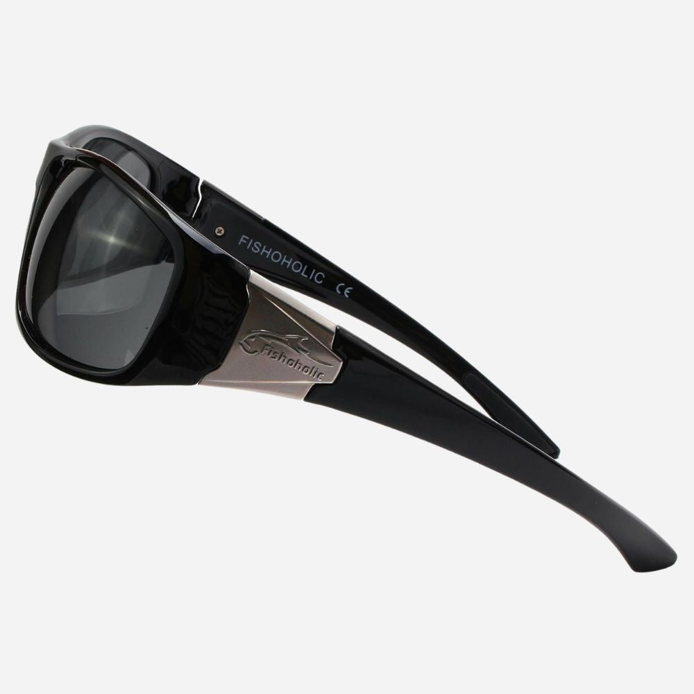 Black sunglasses with dark lenses and a silver metal bridge, featuring the brand name FISHONGLIC printed on the temple arm, set against a light gray background.