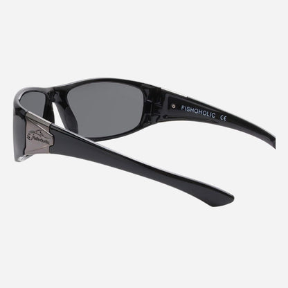 Black sunglasses with dark lenses and silver metal temples, shown from a side angle on a light gray background. The brand name FISHOHOLIC is printed on the inside of the temple arm.