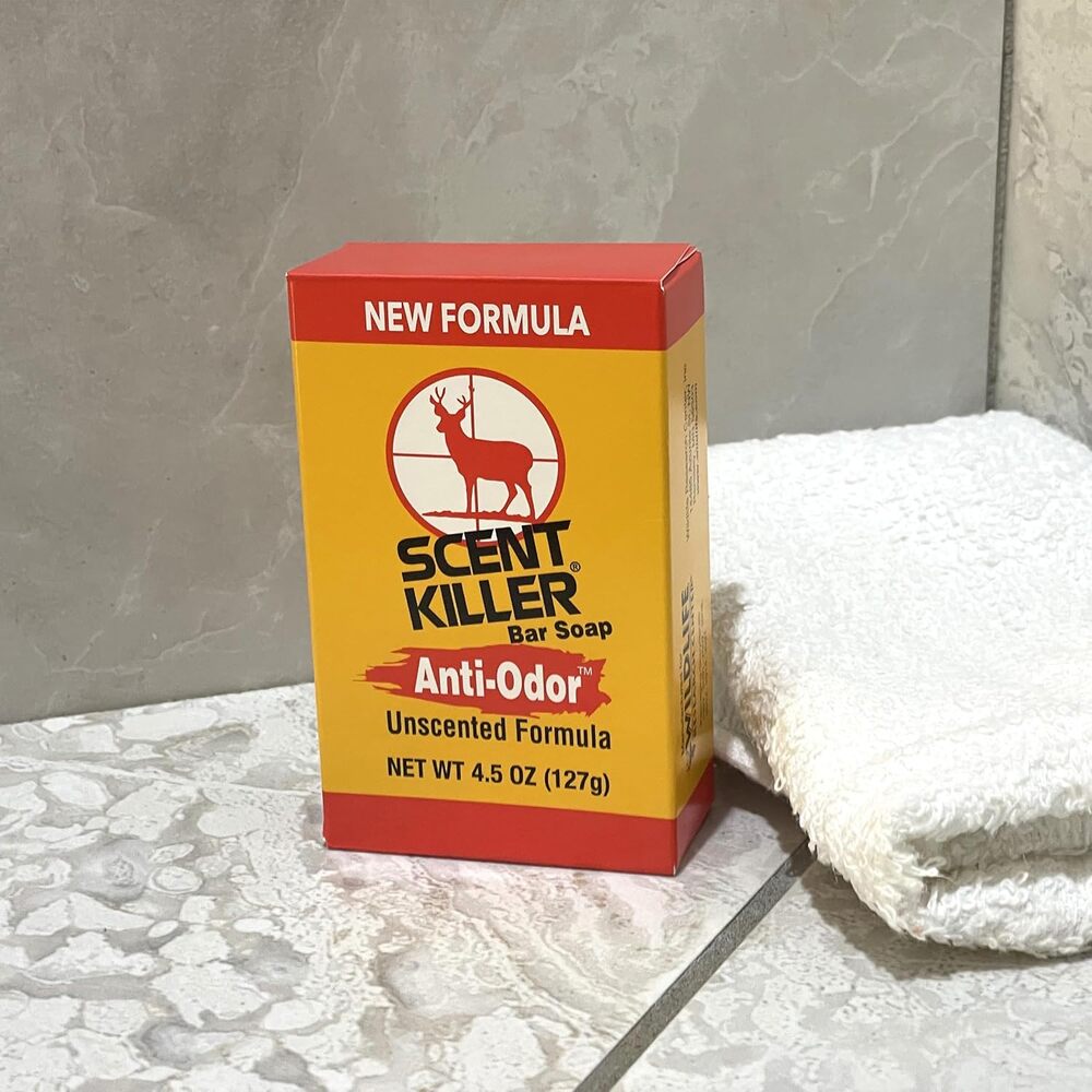 Box of Scent Killer bar soap on a stone surface with a towel in the background