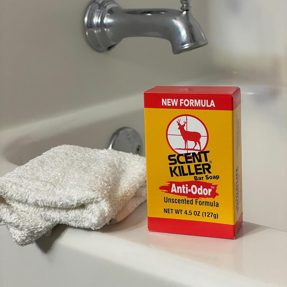 Box of Scent Killer Anti-Odor Bar Soap on a bathroom counter with a towel and faucet in the background.