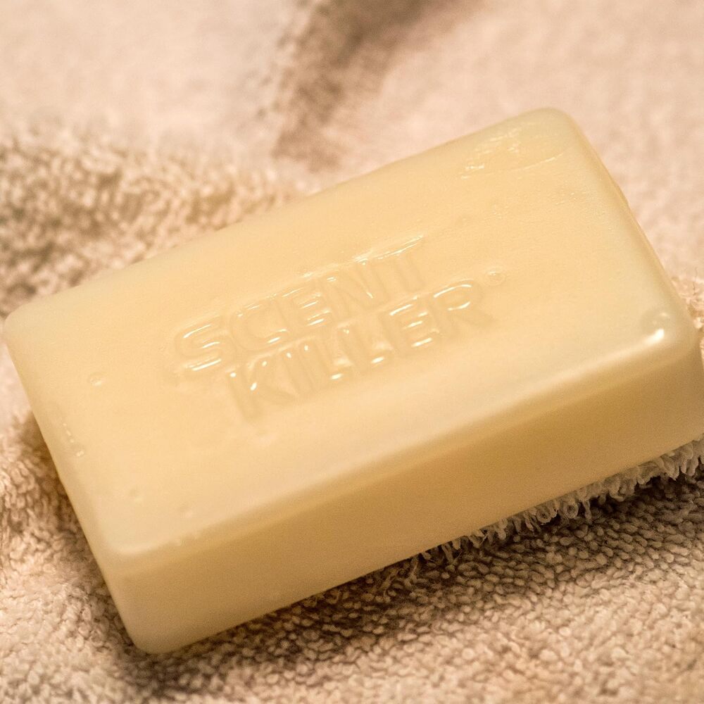 Bar of soap with scent killer brand on a textured surface