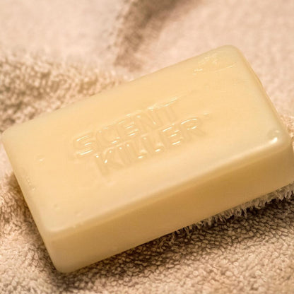 Bar of soap with scent killer brand on a textured surface