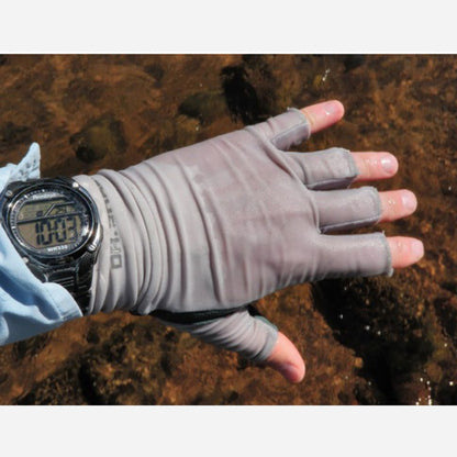 Hand wearing a gray fishing glove with a digital watch, over a natural background.