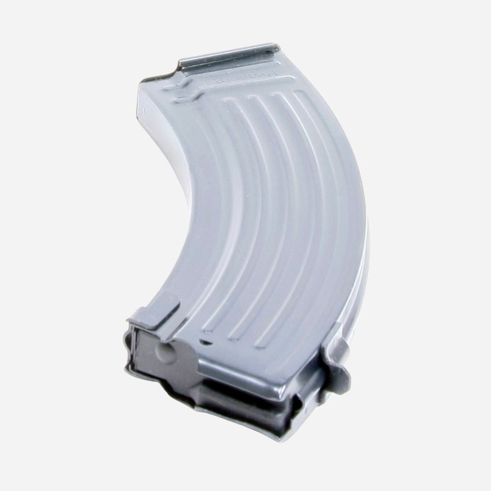 A curved metallic silver magazine or clip-shaped component with ribbed ridges, shown on a plain light gray background.