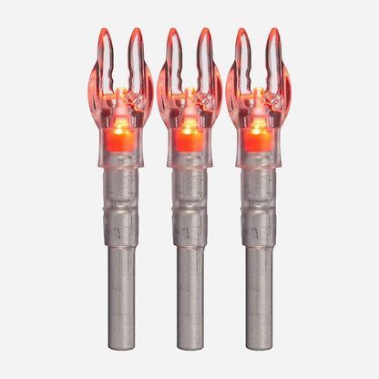 Three metallic arrow nocks with glowing orange tips on a white background
