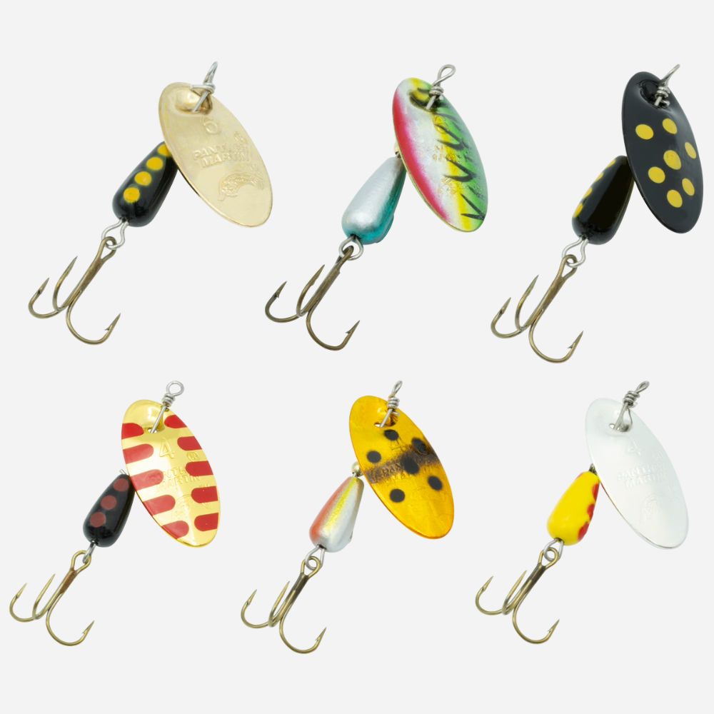 Six fishing spinnerbait lures arranged in two rows on a light gray background. The lures have treble hooks and are painted in various colors including yellow, black, red, green, blue, and silver.