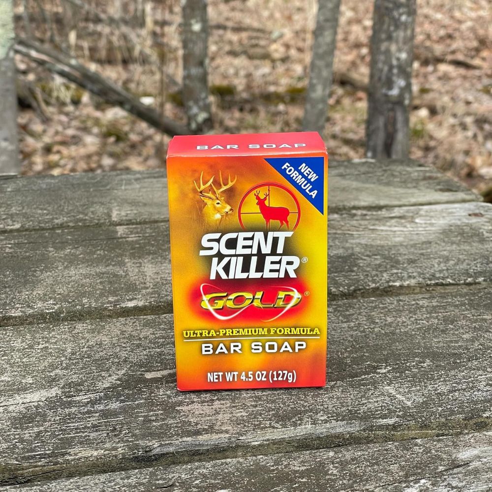 Scent Killer Gold bar soap packaging on a wooden surface with a natural background