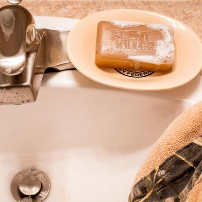 Bar of soap labeled 'Scent Killer' on a soap dish over a sink.
