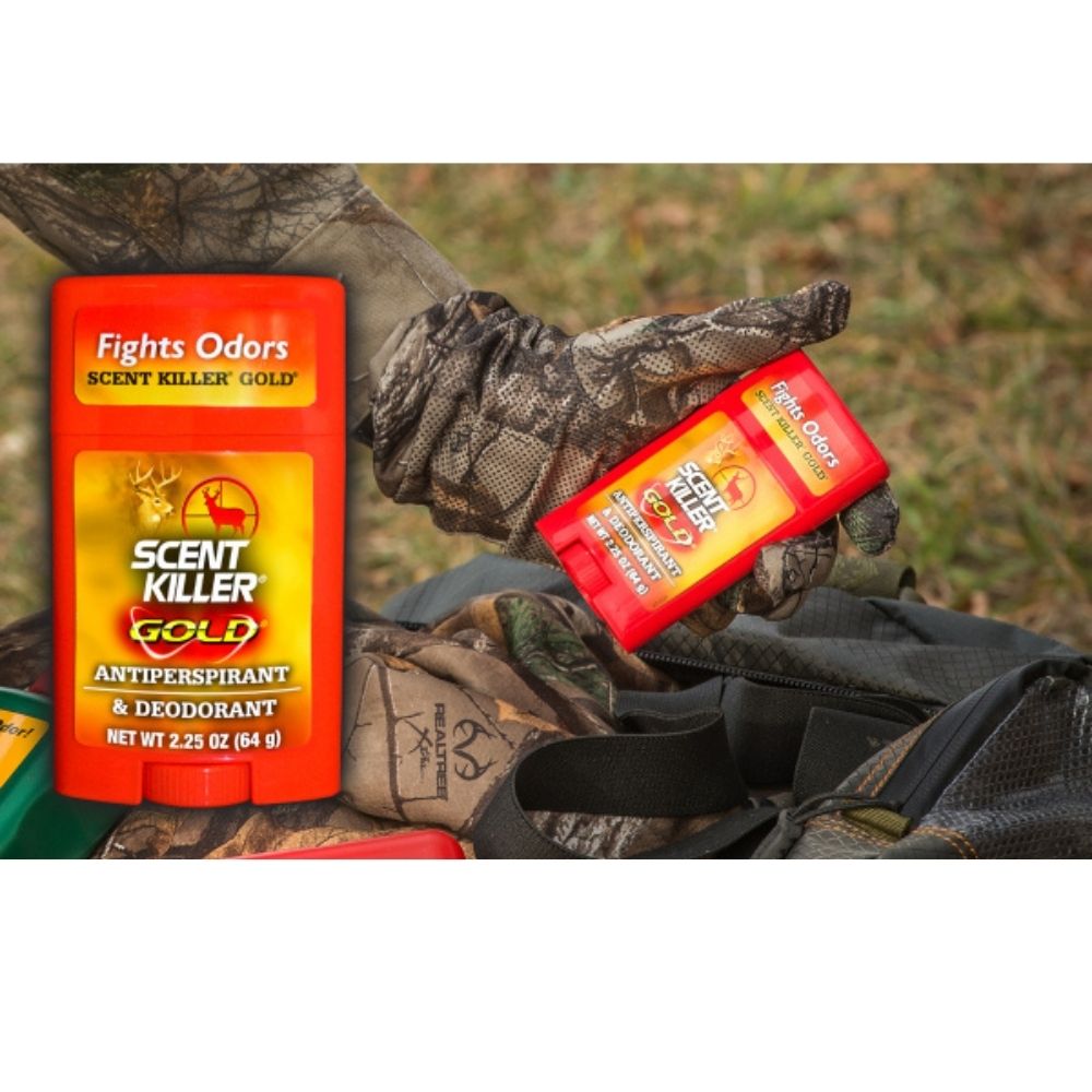Scent Killer Gold antiperspirant and deodorant stick shown in gloved hands outdoors