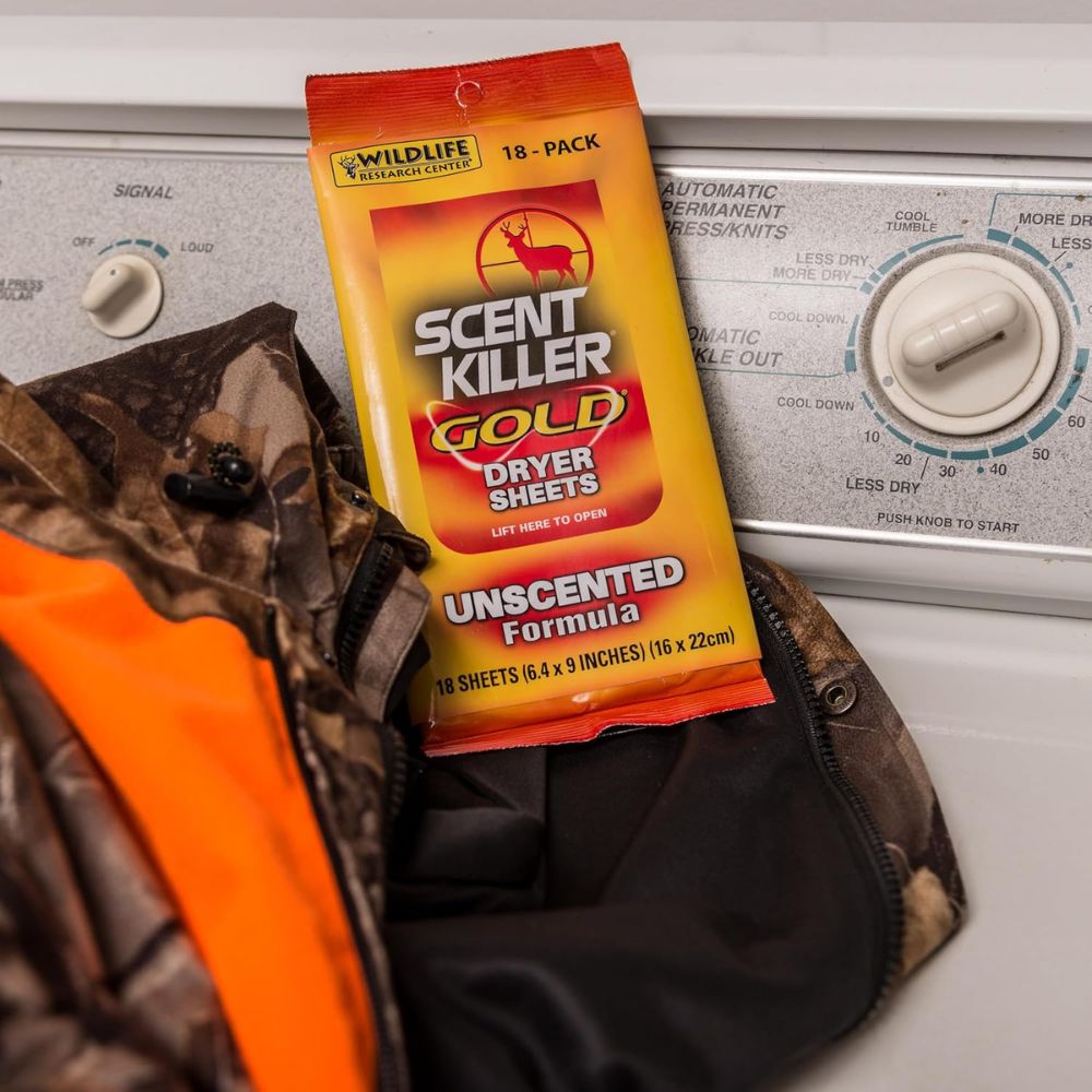 Pack of Scent Killer Gold Dryer Sheets on a dryer with camouflage clothing.