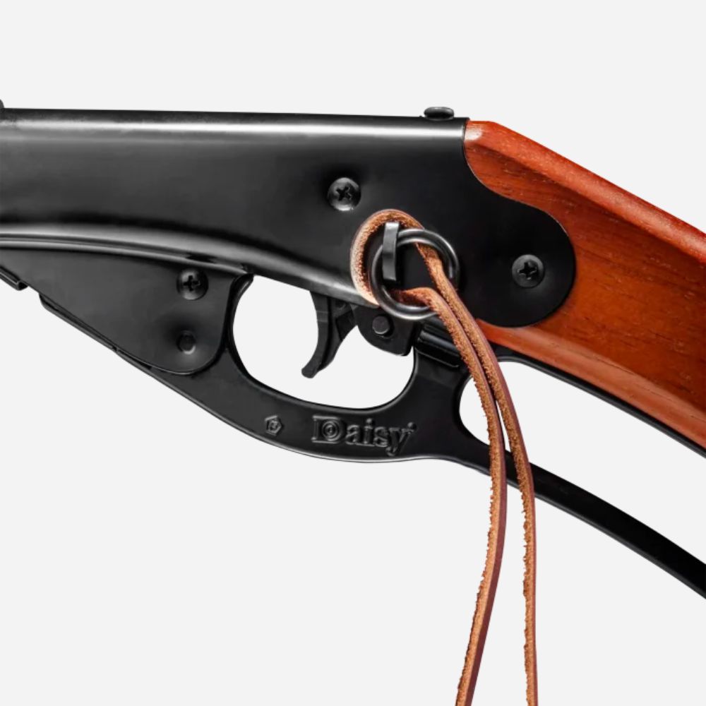 Close-up of a Daisy air rifle trigger mechanism on a white background