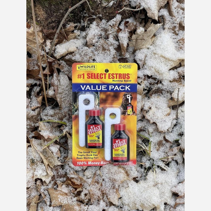 Packaged hunting scent product on a snowy ground