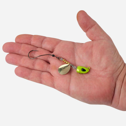 Fishing lure held in a hand against a white background