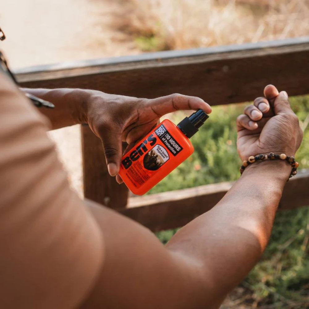 Person holding a bottle of Betta's product outdoors