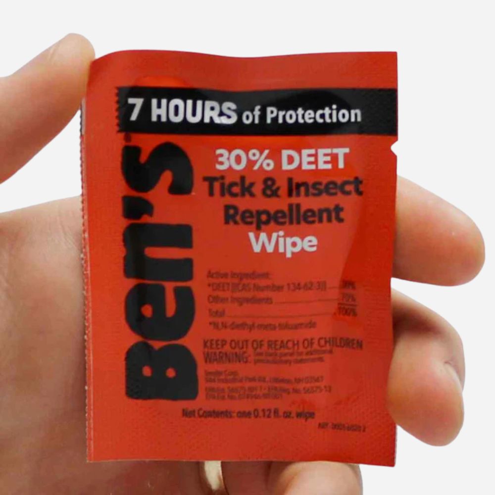 Ben's Tick & Insect Repellent Wipe packaging held in a hand with a white background