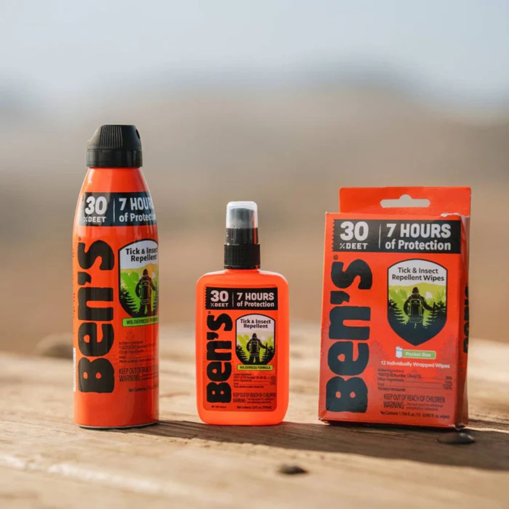 Ben's tick and insect repellent bottles and packaging on a wooden surface.