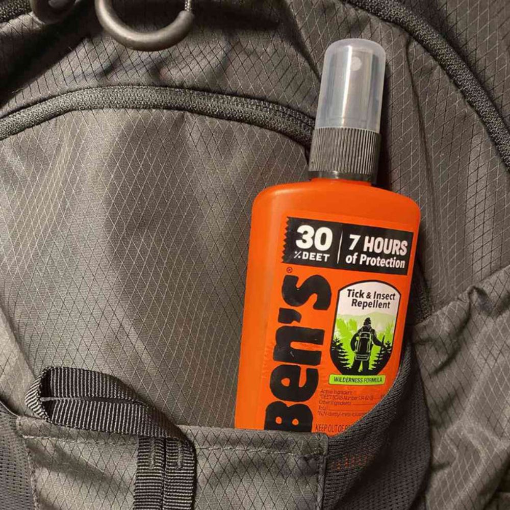 Ben's Tick & Insect Repellent bottle on a gray backpack