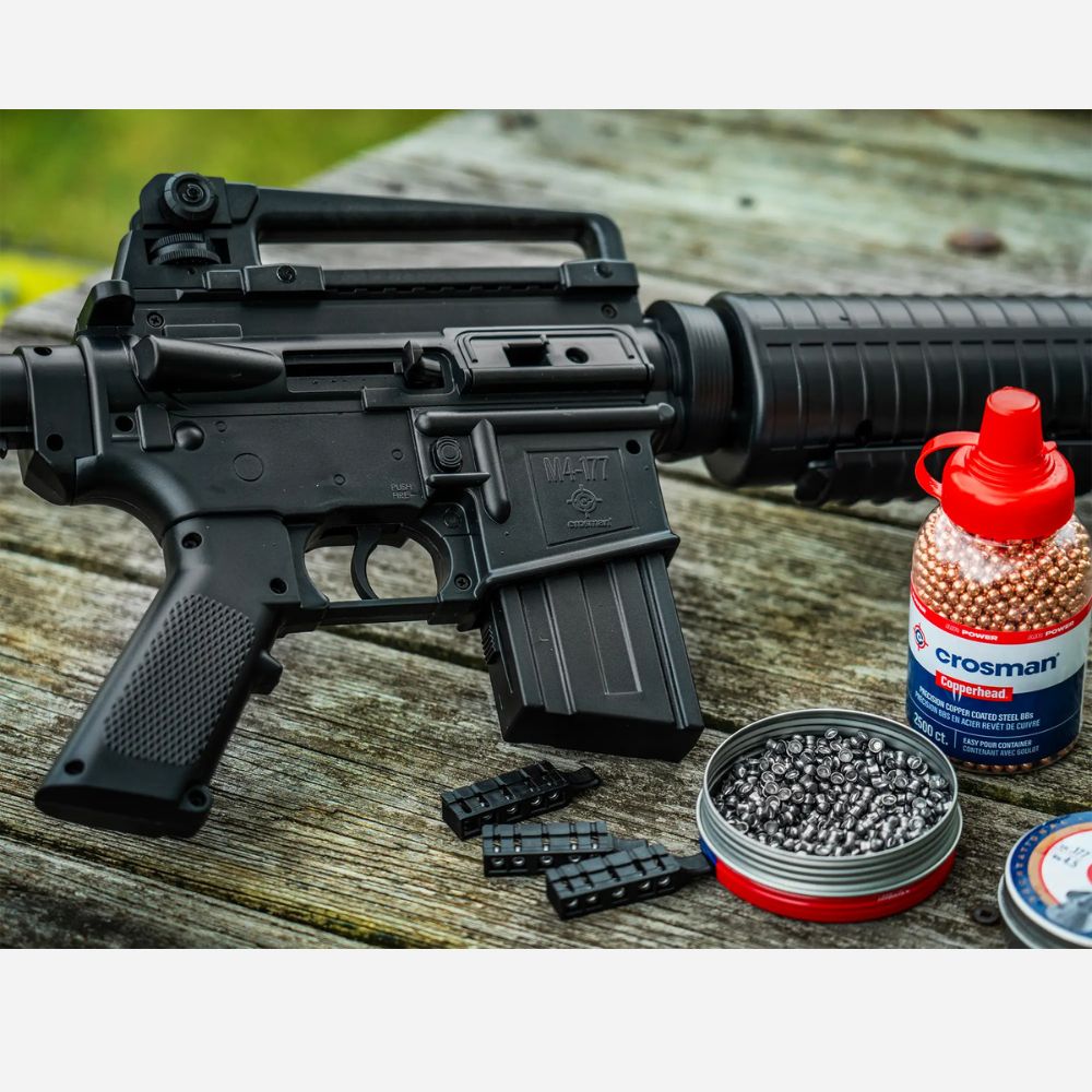 Black rifle with Crosman ammunition on a wooden surface