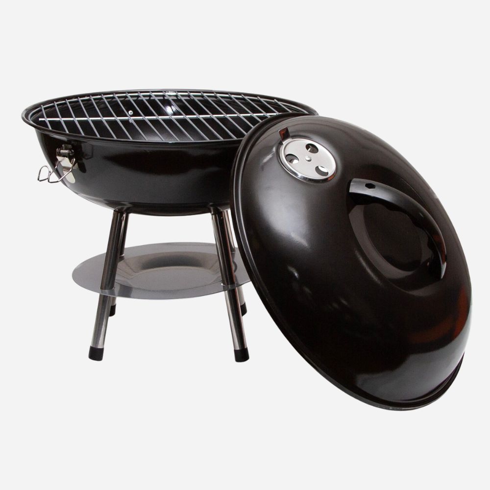 Black charcoal grill with lid on a white background