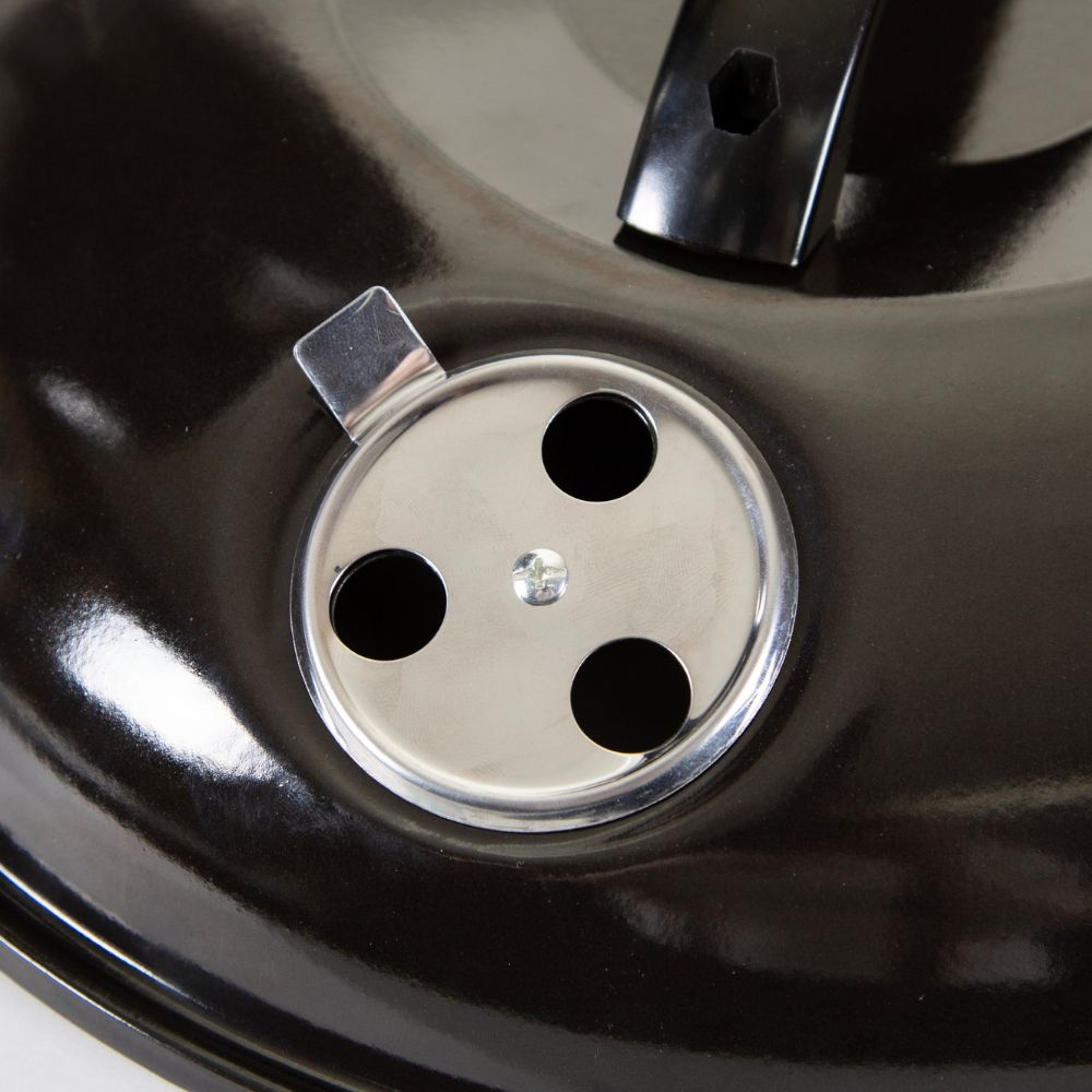 Close-up of a black car wheel with a silver rim cap.