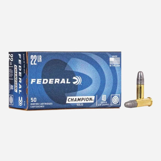A box of Federal Champion 22 LR caliber cartridges shown on a light gray background, with two loose cartridges displayed to the right of the box.