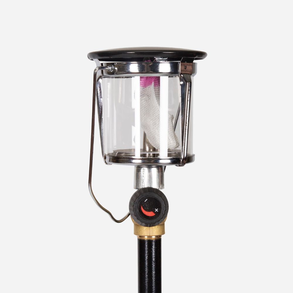 Clear camping lantern with black top and hose attachment on a white background