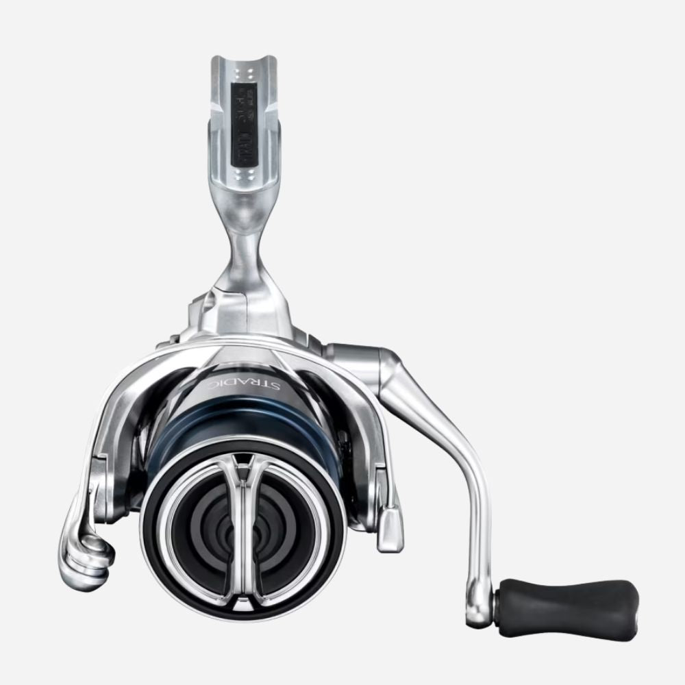 Fishing reel with metallic finish on a white background