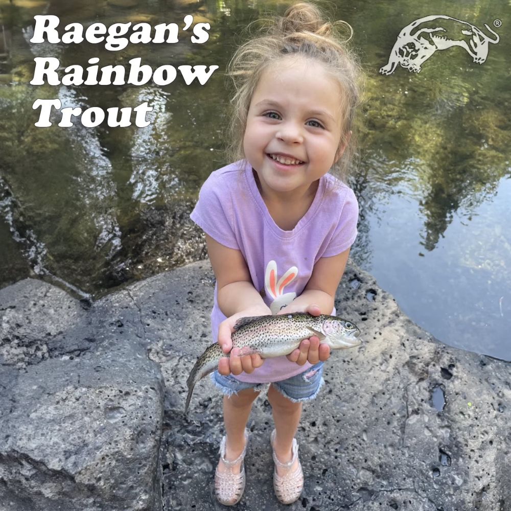 Young girl holding a rainbow trout by a stream with 'Raegan's Rainbow Trout' text and logo.