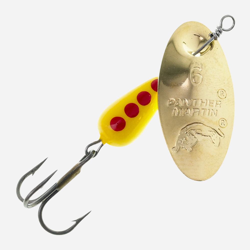 A Panther Martin fishing spinnerbait lure with a gold-colored metal blade, a yellow body, three red dots, and two treble hooks, shown on a light gray background.