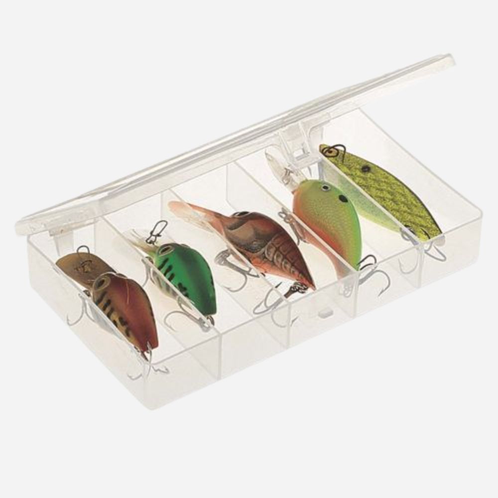 Set of colorful fishing lures in a clear box on a white background