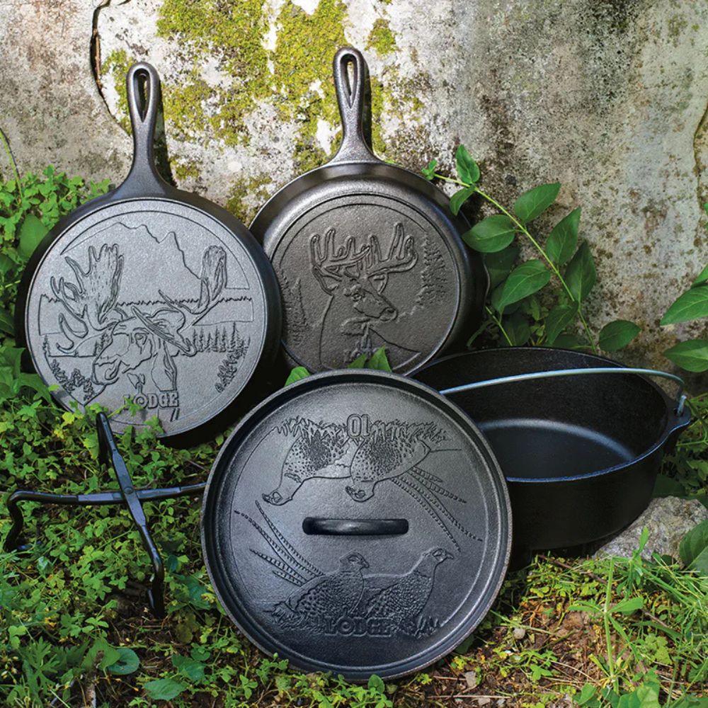 Three cast iron skillets with engraved designs on a natural background