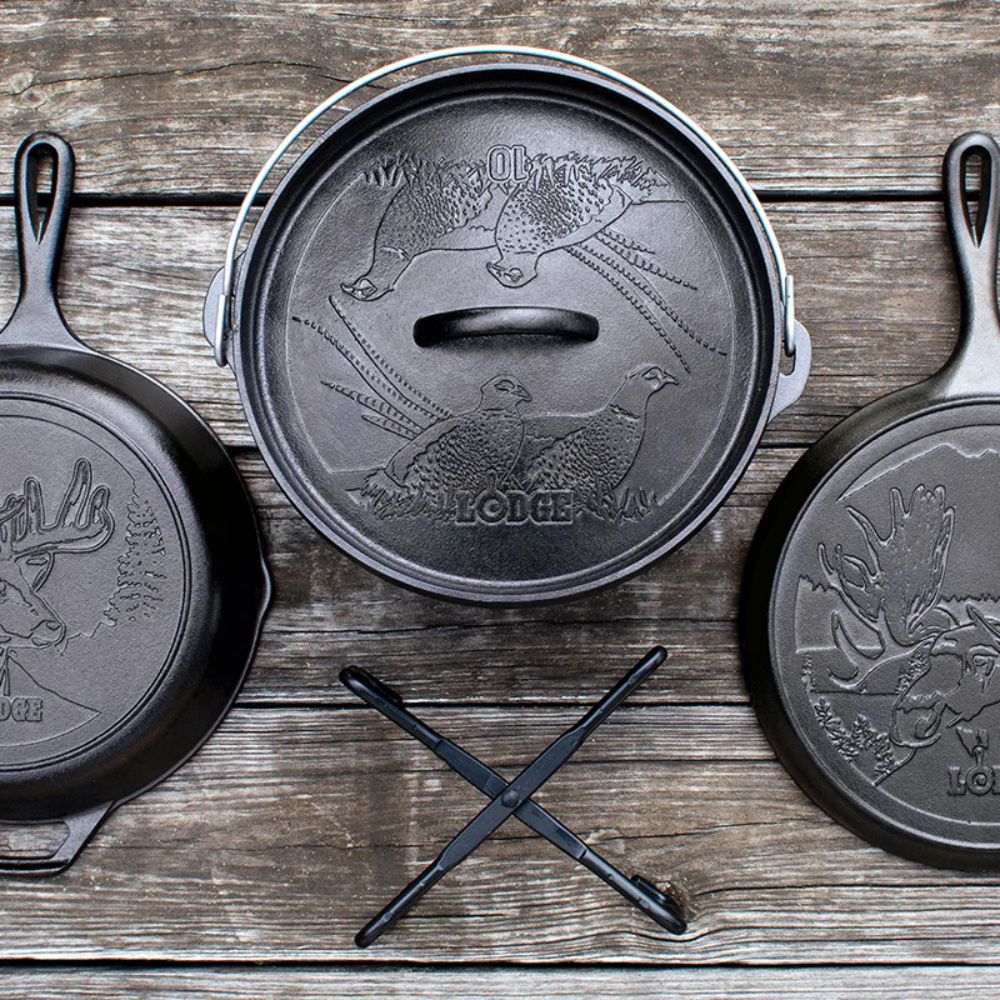 Three cast iron skillets with decorative lids on a wooden surface