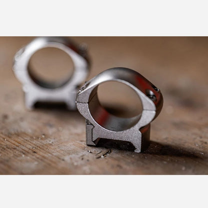 Metal ring with a unique design on a wooden surface