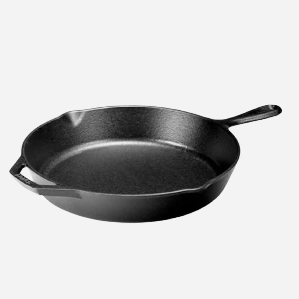 Black cast iron skillet on a white background